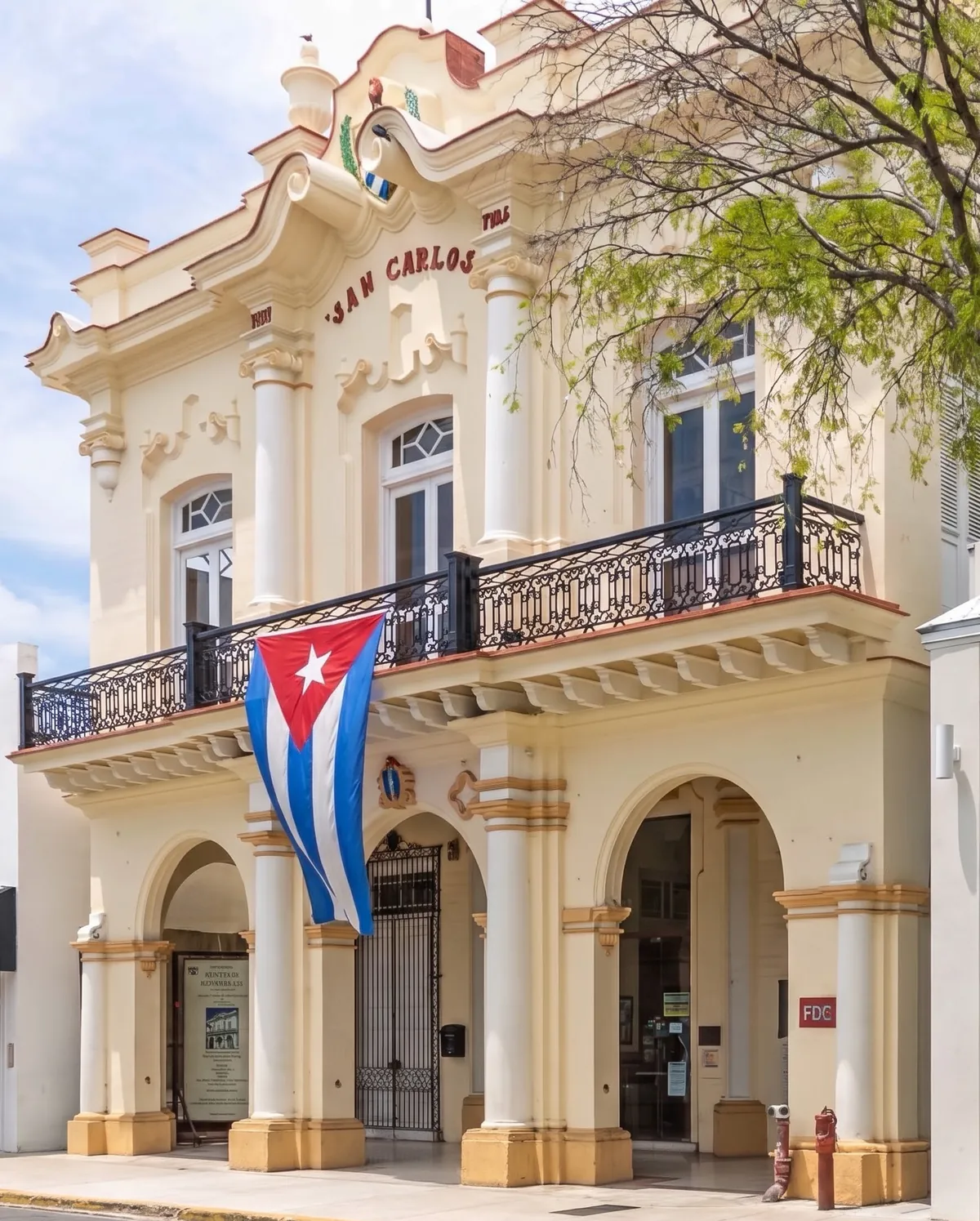 The San Carlos Institute on Duval Street, with a Cuban flag hanging from the balcony and "San Carlos" above the windows